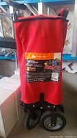 Red collapsible folding wagon with visible Ozark Trail branding and product label on the cover.