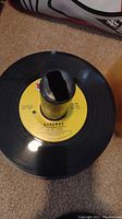 Close-up of 45 RPM vinyl record label 'Runaway' by The McCoys with yellow center label and central hole visible.