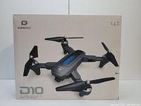 Front view of boxed Deerc D10 drone showing product image, branding, and features included such as HD camera and flight modes.