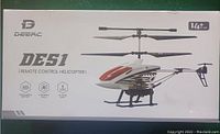 Photo of the Deerc DE51 remote control helicopter box showing the model, features, and recommended age 14+. The box is white with an image of the helicopter shown clearly.