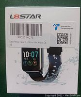 Photo of L8STAR Fitness Tracker in original packaging showing the device on the front with black band, color screen displaying time and health data, and water splash graphics indicating water resistance.