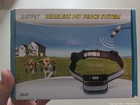 Front image of the box showing product name, image of two dogs, collar device, and wireless signal concept.