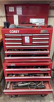 Full front view of red rolling tool chest with drawers open