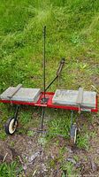 Full view of Craftsman dirt and gravel drag with concrete weights on frame, handle upright, on grassy ground.