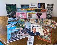 Photo showing the entire collection of vintage travel brochures, postcards, decal packs arranged on a table.