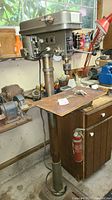Full view of floor standing drill press showing base, column, table, and head