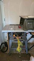 Full front view of the Craftsman table saw showing metal work surface, legs, and front control panel.
