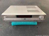 Front view of the Panasonic SA-HT75 DVD home theatre system receiver showing controls and display.