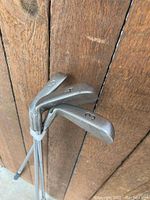 Close-up of Ping golf club iron heads showing numbers 3, 4, and 6.