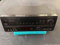 Front view of Pioneer VSX-604S stereo receiver showing control buttons and knobs, input ports, and headphone jack.