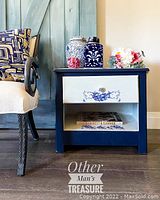 Night stand showing overall navy frame with white drawer and shelf front. Stage items not included.