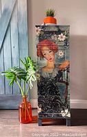 Front view of tall storage cabinet with decoupage design