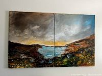 Front view of two acrylic paintings on canvas hung side by side showing the complete landscape diptych with dark hills, water body and sky.