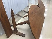 Side view showing folding flaps and carved oak legs with support frame under pine wood top.