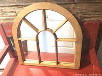 Front view of wooden arched window frame mirror with multiple window pane divisions, showing reflective glass section and solid wood construction.