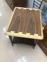 Top-down view showing walnut veneer center and pecan dovetail corner inlays