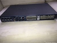 Front of MOTU Traveler mk3 showing input trims, headphone jack and CueMix FX mixer knobs