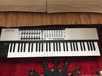 Full front view of the Novation 61SL MkII on patterned rug