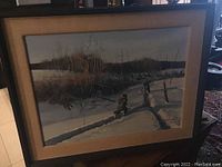 Full view of framed painting showing winter landscape scene with father and son