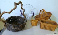 All four baskets together showing varying sizes and unique handle designs