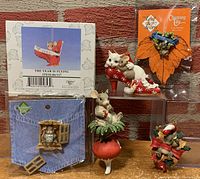 Photo of all six items: four ornaments and two pins including one in original box, showing detailed mouse figurines and packaging