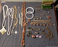Full view of all jewelry items laid out including necklaces, bracelets, earrings, pins, hair combs, and bangles.