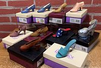 Ten miniature collectible shoes from Just The Right Shoe displayed on their original boxes. Several styles and colors shown including blue, gold, pink, brown, silver, and turquoise.