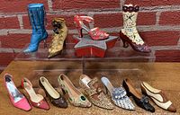 Lot of 12 miniature decorative shoes arranged in two rows showing variety of styles and colors.