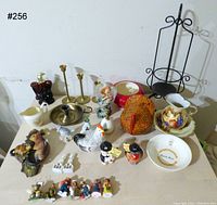 Wide view of all items included showing variety of ceramics and metal candle holder.