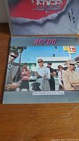 Photo of AC/DC Dirty Deeds Done Dirt Cheap album cover showing group of men in suits with sunglasses outdoors