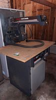 Full front view of the 10-inch Sears Craftsman radial arm saw on a stand in a workshop setting.