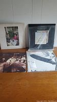 Overview of four Led Zeppelin LP albums laid out on wooden surface.