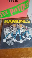 Pink cover reading HERE’S THE Sex Pistols alongside Ramones Road to Ruin sleeve