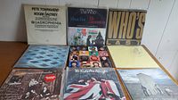 Overview photo showing all nine The Who LP albums arranged in a grid on a wooden surface. Covers include Quadrophenia, The Who's The Who Collection, Who's Last, The Kids Are Alright, and others.