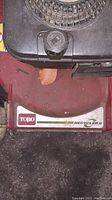 Close-up of Toro logo and Recycler II decal on red mower body