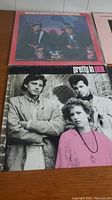 Pretty in Pink soundtrack album cover with three individuals in black and white, person in front wearing a pink top.