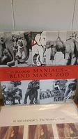 Vinyl record cover of 10,000 Maniacs 'Blind Man's Zoo' showing a black and white collage of elephant and people images with a red title band.