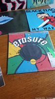 Overview of multiple vinyl covers including unknown abstract red cover, unknown dark cover with shapes, Black Flag My War, Erasure Circus