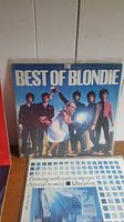 Photo showing 'The Best of Blondie' vinyl album cover and partially the next record with blue mosaic design