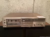 Front view showing the full face of the Dual C828 cassette player with cassette compartment, buttons, knobs, and display.