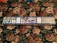 Box of NewAge garage shelving organizer with brand and product images.