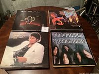 Photo of four featured records on a wooden table: Quincy Jones 'The Dude', David Bowie 'Scary Monsters', Michael Jackson 'Thriller', and Deep Purple 'Machine Head'.