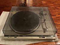 Front view of Technics SL-D20 turntable with dust cover lowered, showing overall unit and front controls.