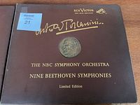 Brown album cover sleeve with gold embossed text showing RCA Victor logo, conductor Arturo Toscanini's signature, medallion image, and text indicating NBC Symphony Orchestra's Nine Beethoven Symphonies Limited Edition set.