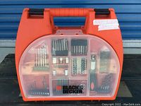 Full view of the closed orange Black & Decker tool case showing contents through transparent lid.