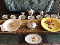 Full display of Punkinhead china set including cups, saucers, teapot, covered dish, serving dishes and plates with character decals
