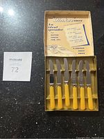 Set of six Dinkee Cutting Utensils with yellow handles in original box
