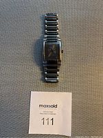 Full view of Kenneth Cole men's wristwatch placed flat showing face and bracelet.