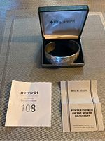 Pewter cuff bracelet inside original Kirk Stieff branded box with MaxSold lot number and paperwork.
