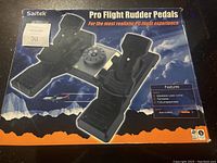 Front view of original Saitek Pro Flight Rudder Pedals box showing product image and feature list.